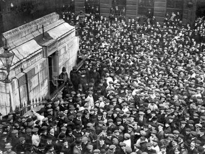 Onlookers gather outside The Monument with the City of London Police stood by the entrance